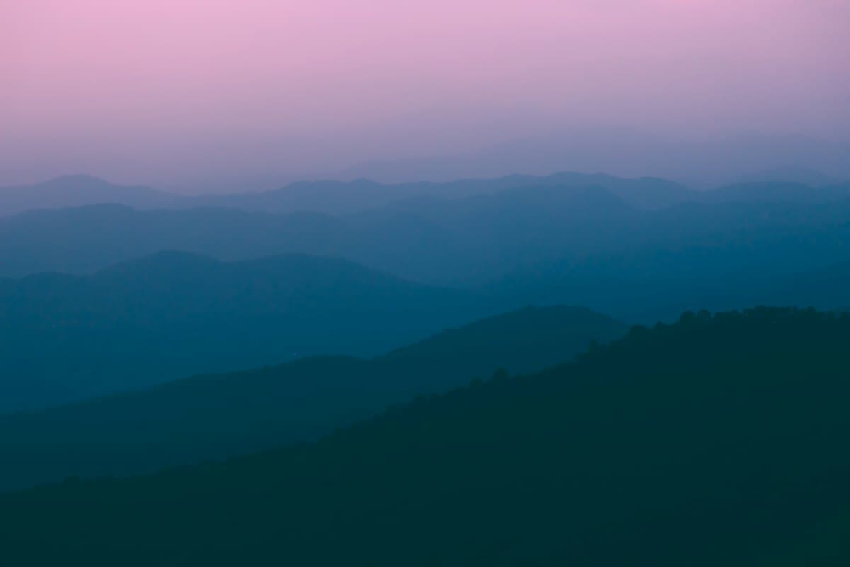 Layers of misty hills at dusk, seen from the Doi Pui viewpoint above Chiang Mai