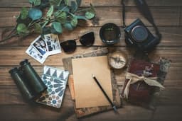 Travel gear laid out on a wooden table